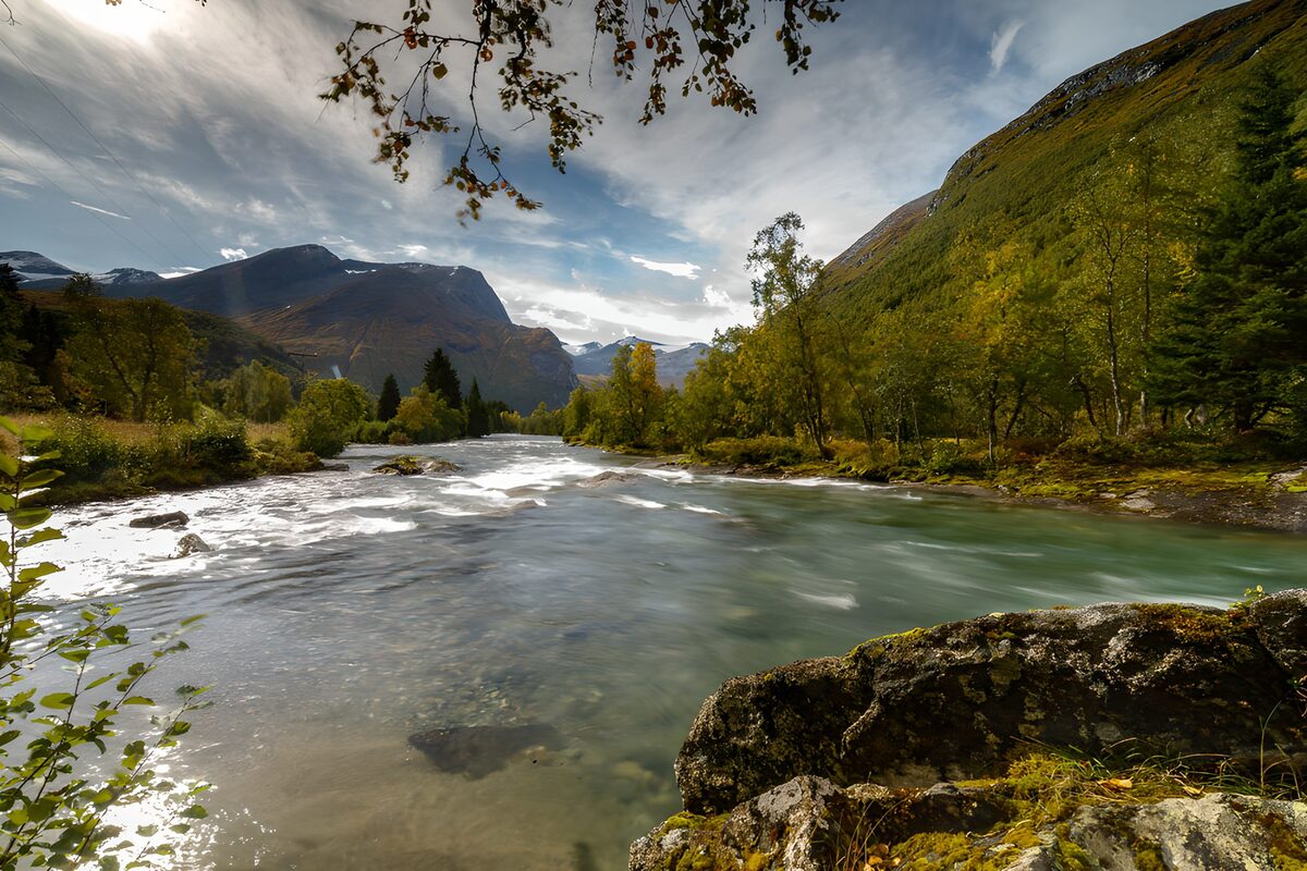 Serene River Flowing Through Mountains