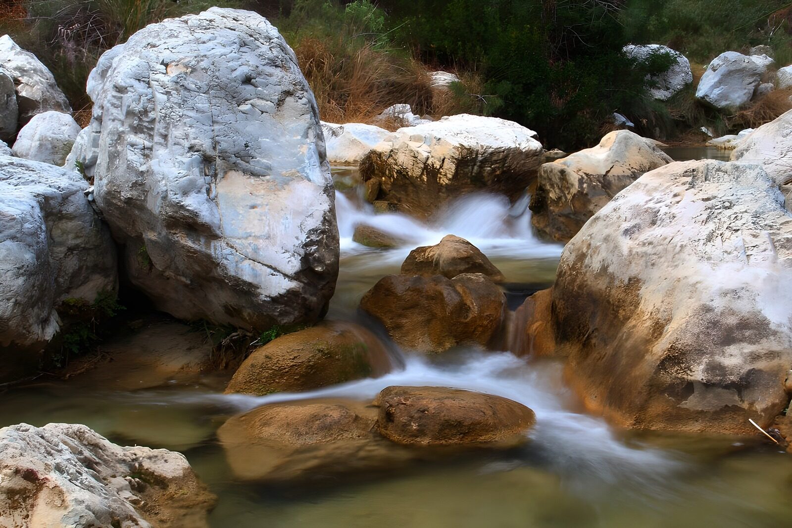 OCCOM3715771: Flowing Stream Over Rocky Terrain