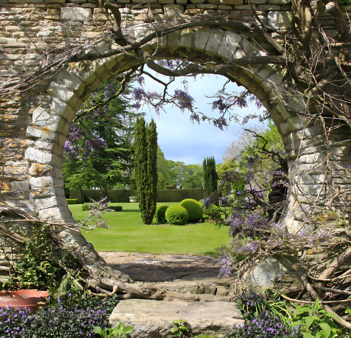 OCCOM7259662: Serene Garden View Through Stone Arch