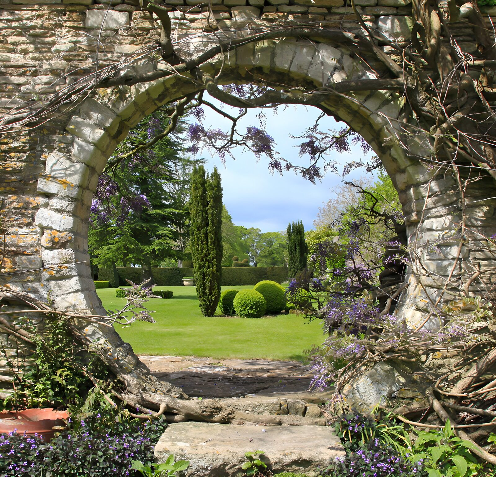 OCCOM7259662: Serene Garden View Through Stone Arch
