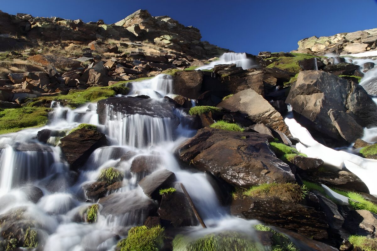 Serene Mountain Stream Flowing Over Rocks