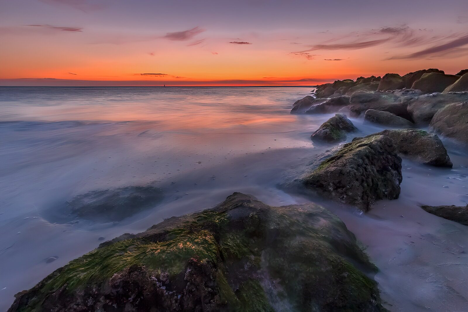 OCCOM8404799: Tranquil Sunset Over Rocky Shoreline
