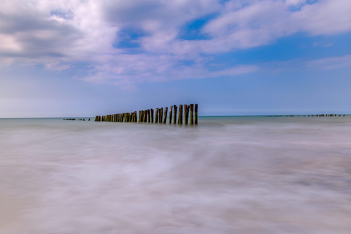 OCCOM5446546: Serene Shoreline with Wooden Posts