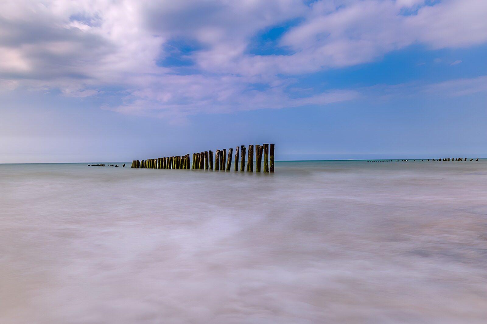 OCCOM5446546: Serene Shoreline with Wooden Posts