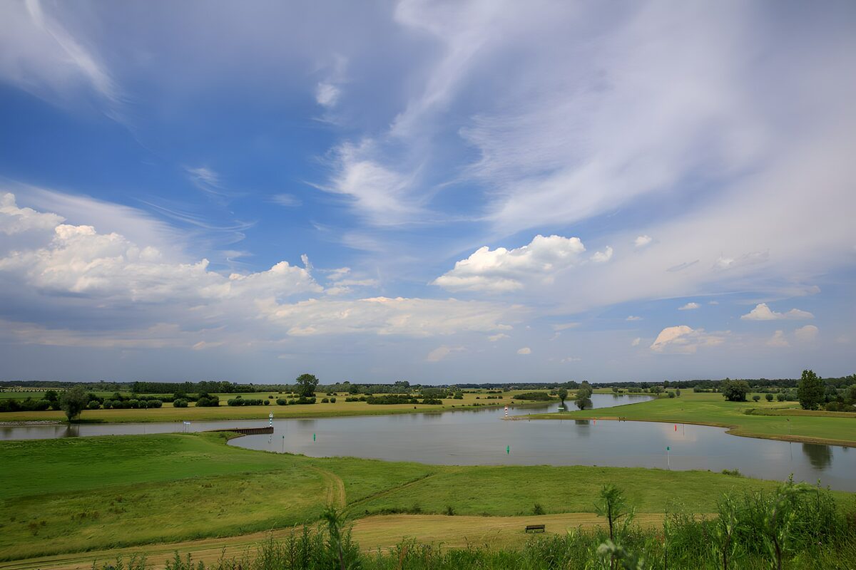 OCCOM5061664: Tranquil River Landscape Under Blue Skies