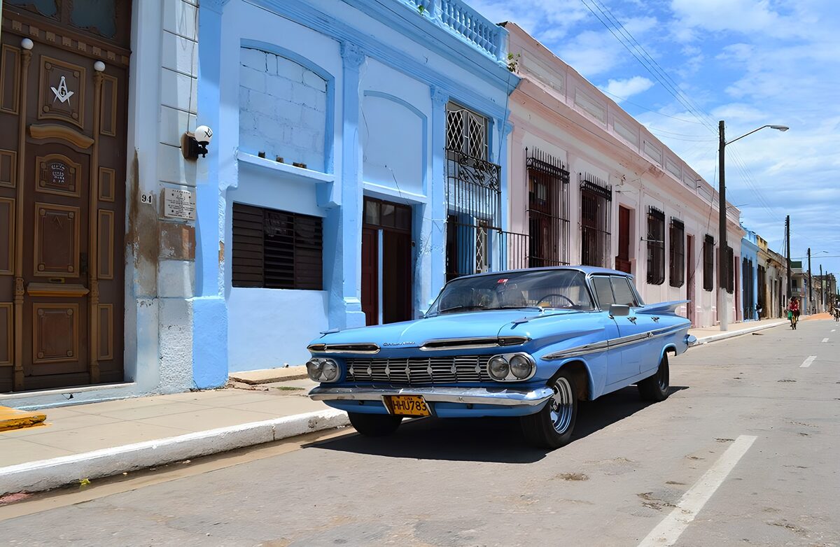 OCCOM3288197: Classic Blue Car on a Colorful Street
