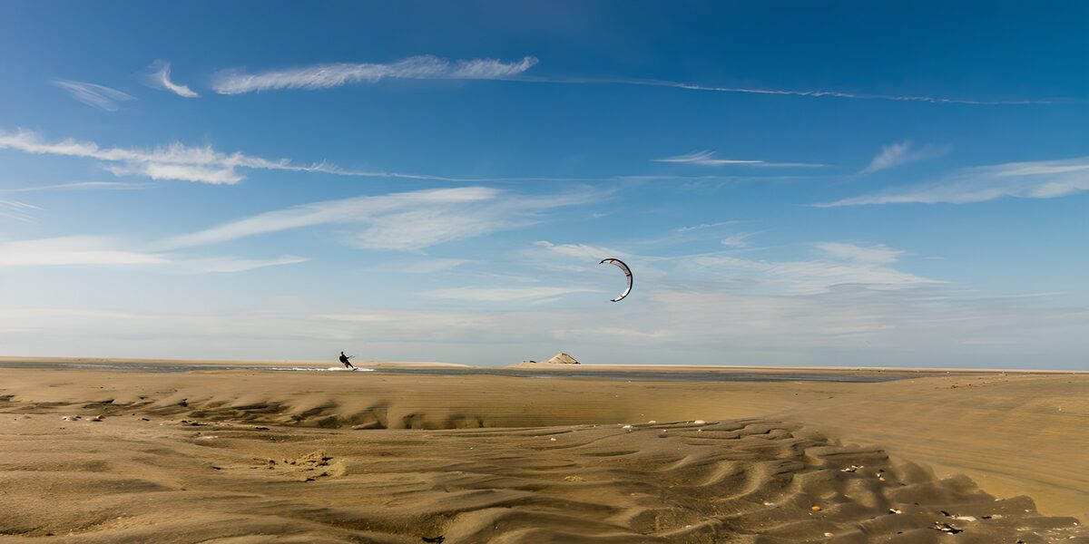 OCCOM1545174: Kite Surfer in the Sandy Dunes