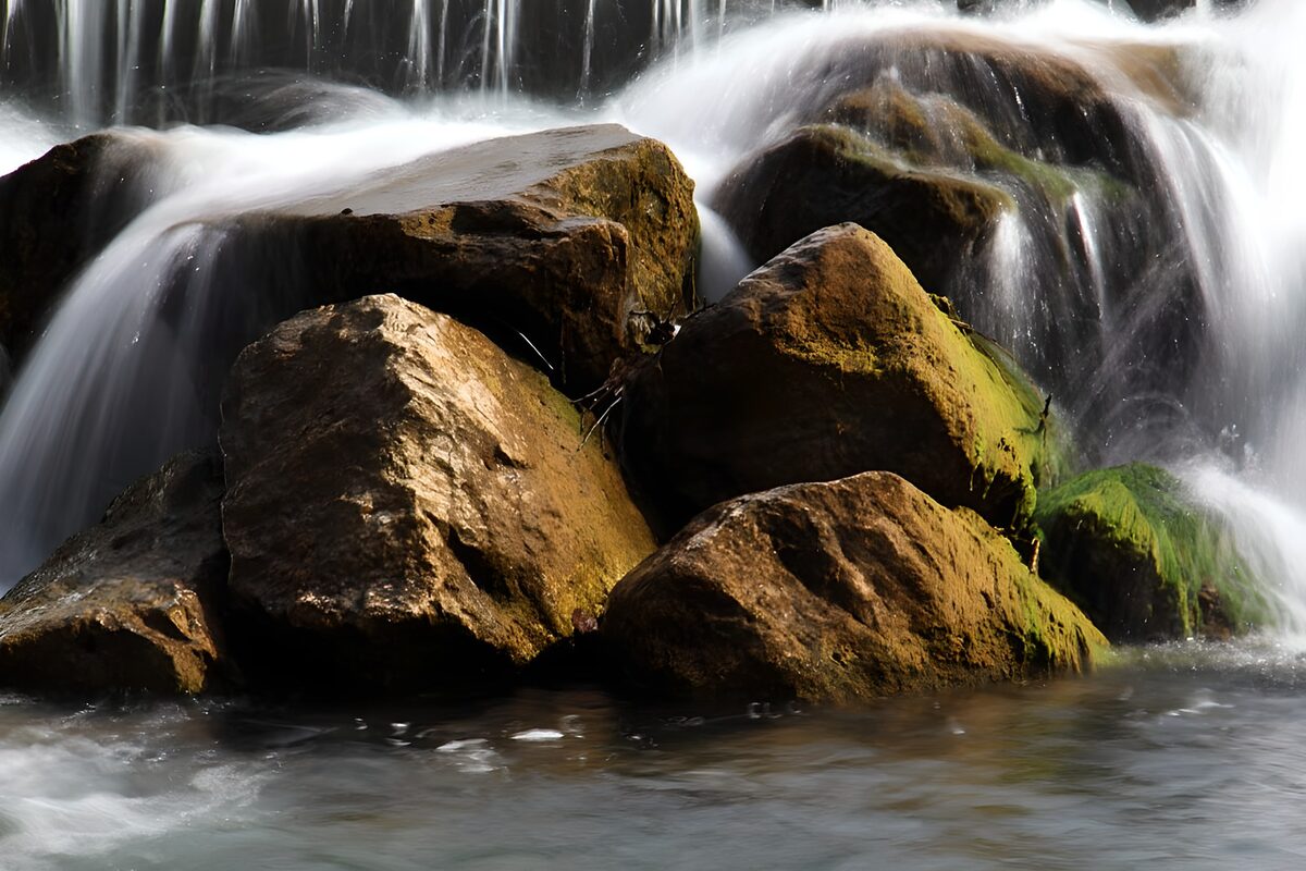 Tranquil Stream Over Mossy Rocks