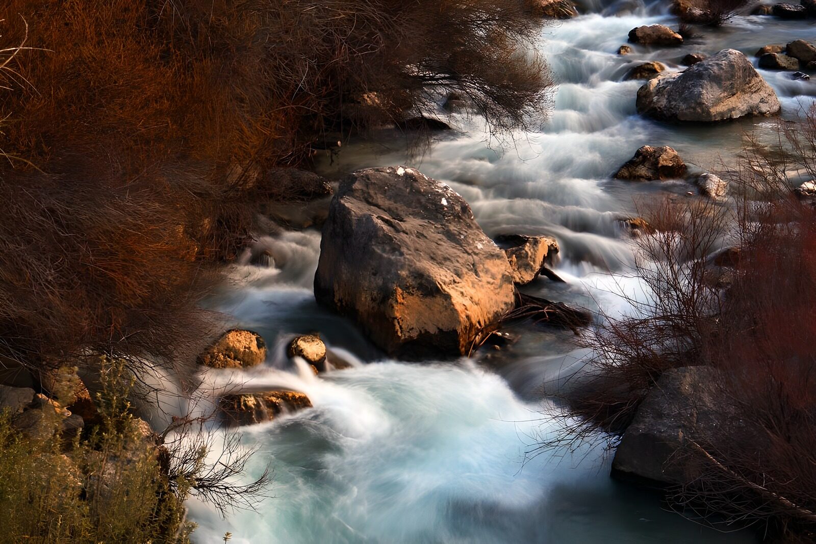 OCCOM6257040: Serene River Flow Through Rocky Landscape