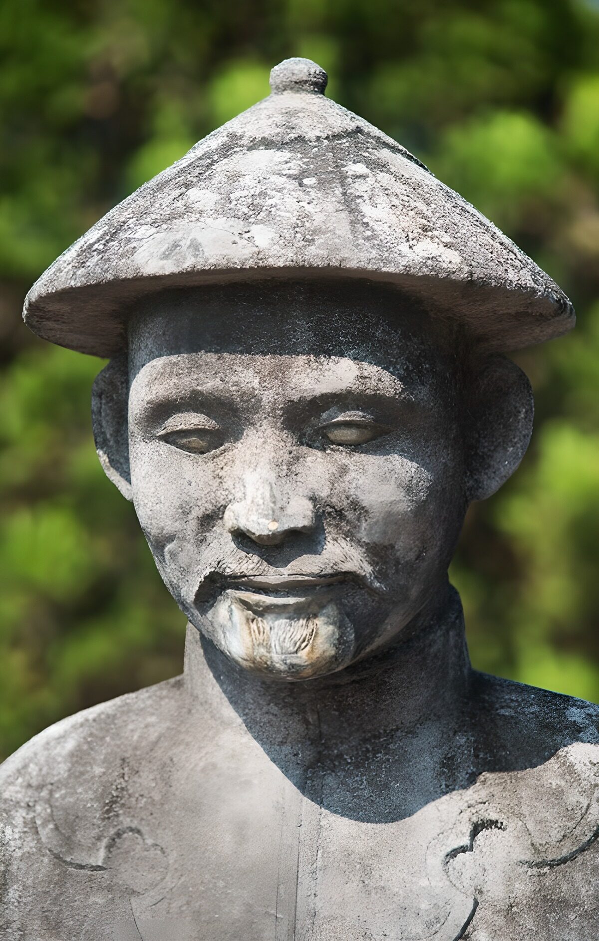 Ancient Stone Statue in Traditional Attire