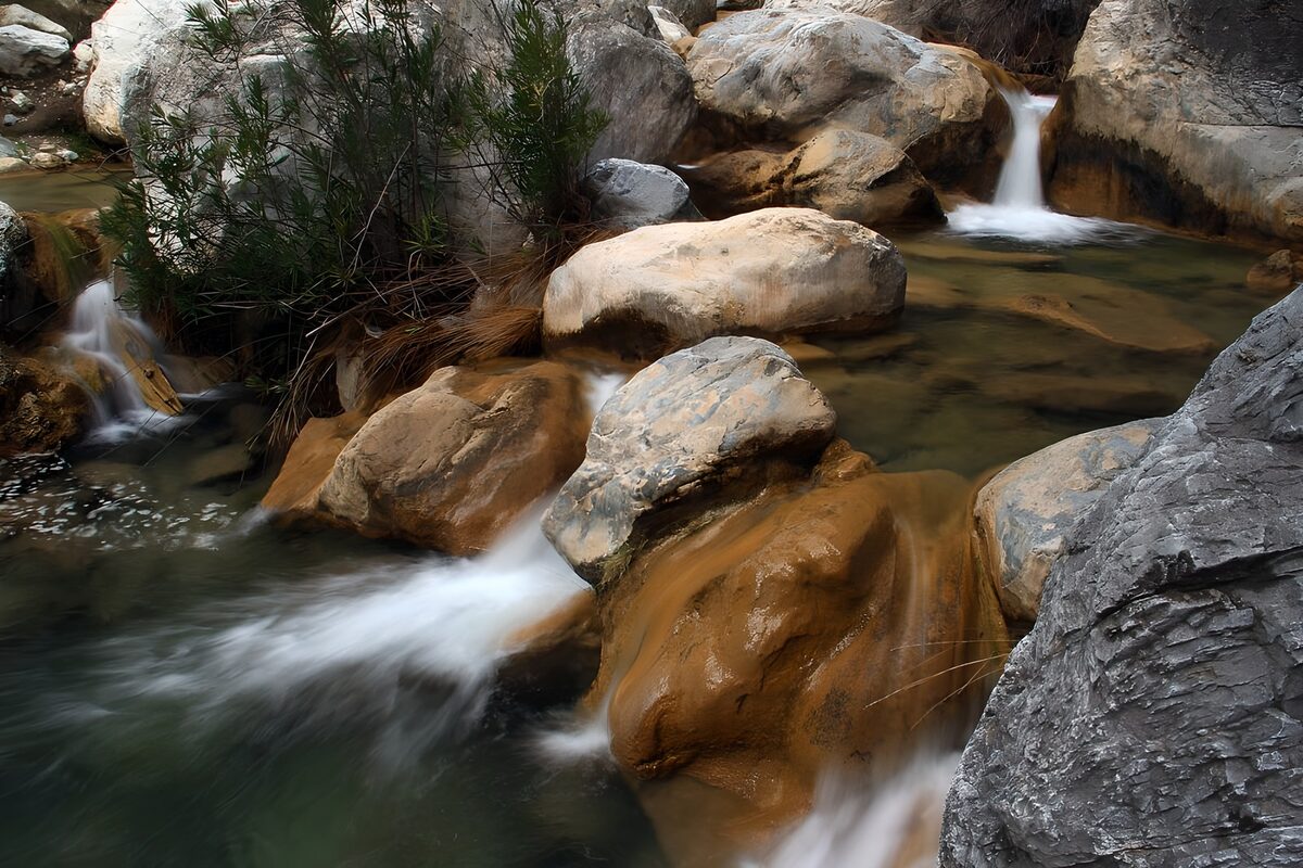 Serene Stream Flowing Through Rocky Landscape