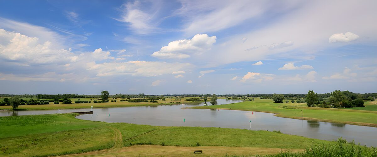 Serene River Landscape under Cloudy Sky
