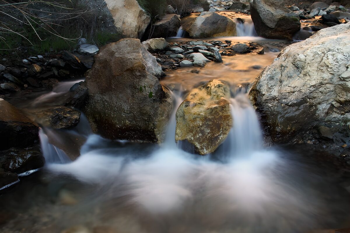 Tranquil Stream Flowing Over Rocks