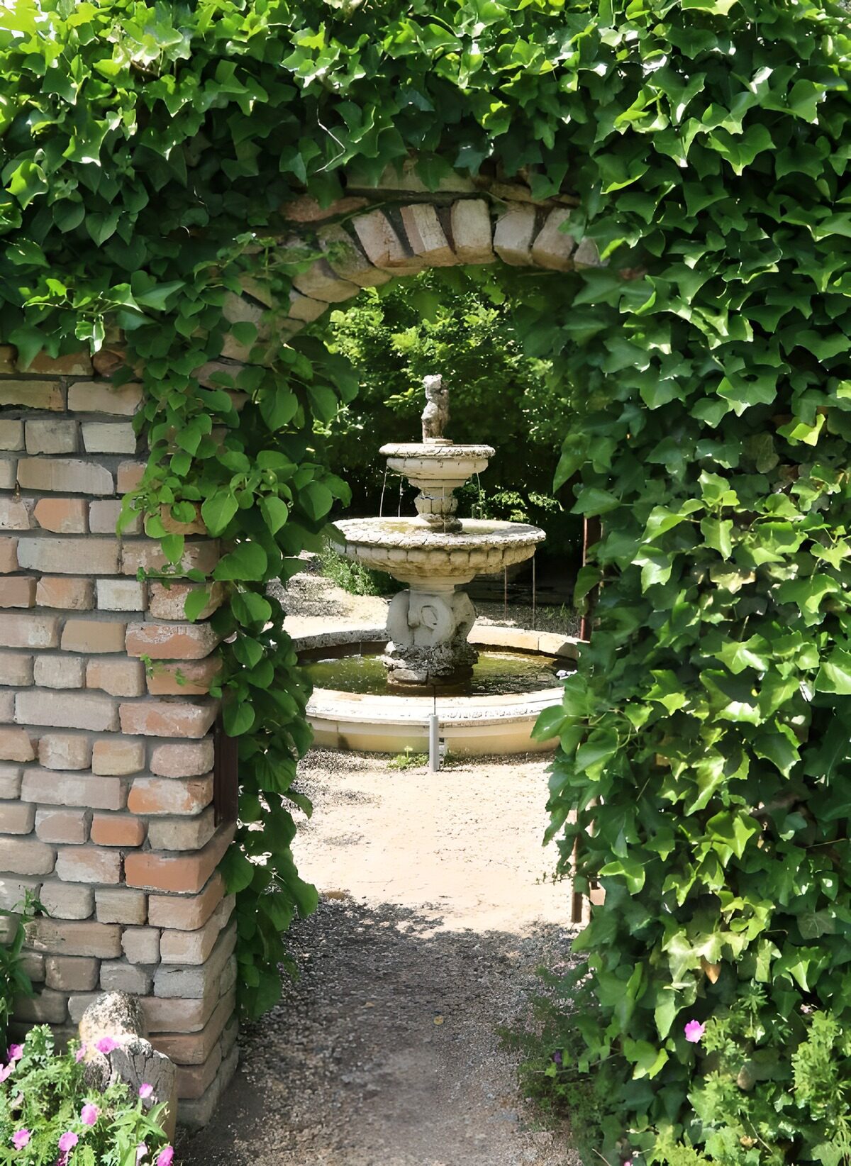 Serene Garden Fountain Through Arched Gate