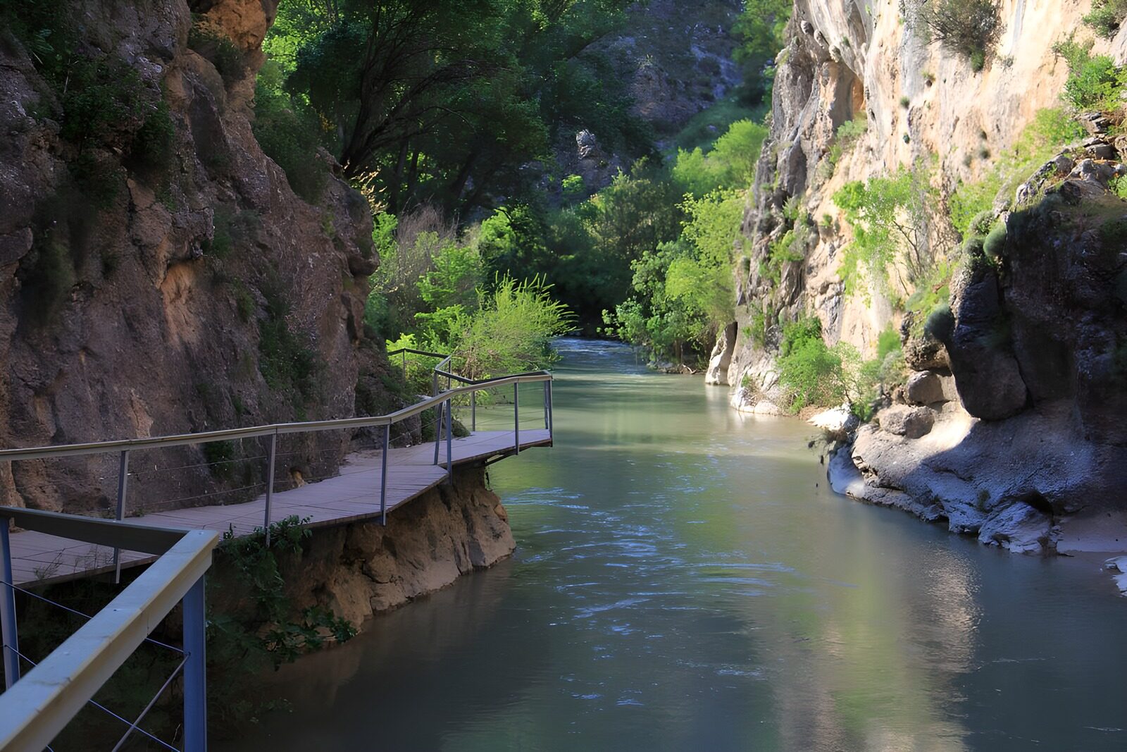 OCCOM6517683: Serene River Between Rocky Cliffs