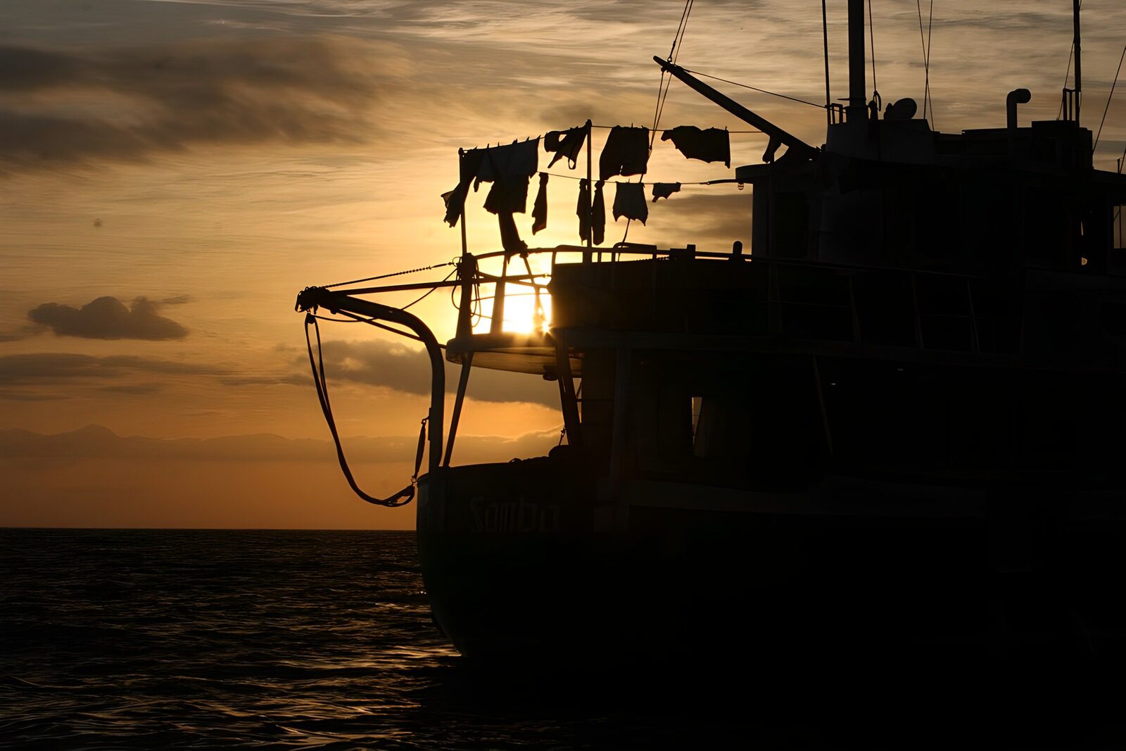 OCCOM4323275: Sunset Silhouette of a Fishing Boat