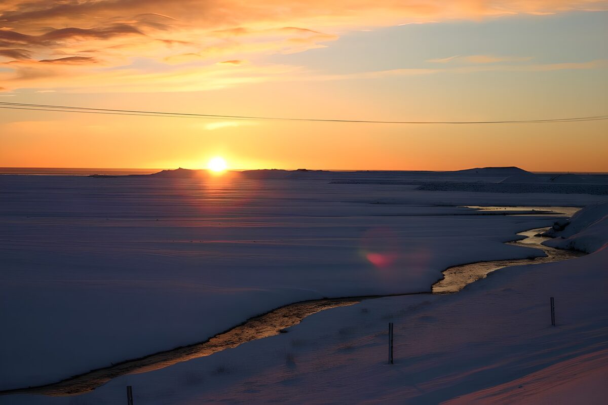 Winter Sunset Over Frozen Landscape